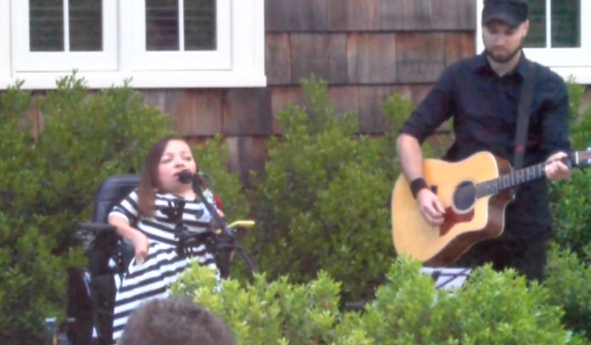 Arlanna Snow, EBHS Class of 1997, performing an original song at the 2018 Bench Dedication